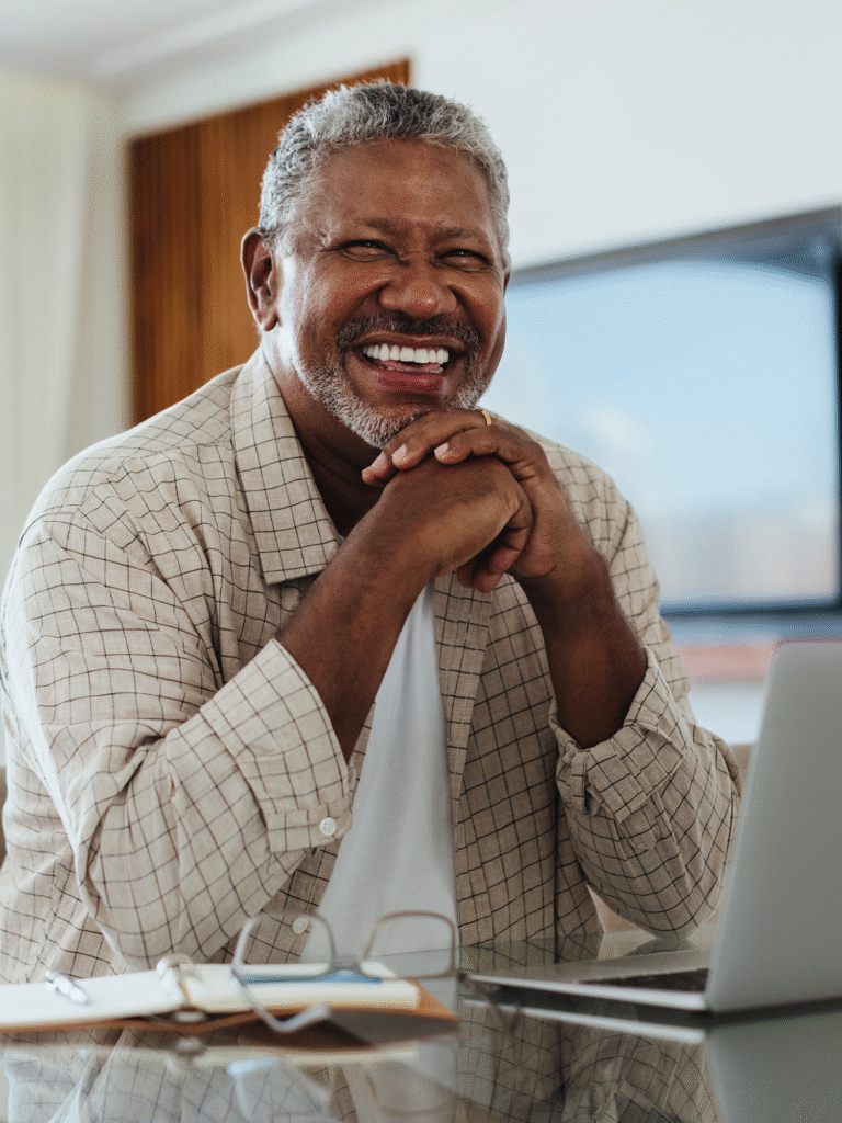man smiling at his computer